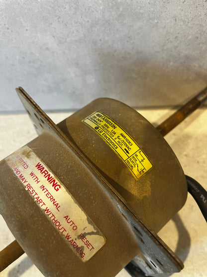 Label on LG motor showing voltage 220-240V, current 10A and warning note