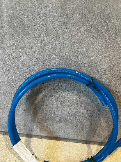 Close-up of blue urethane tubing showing material and printed markings