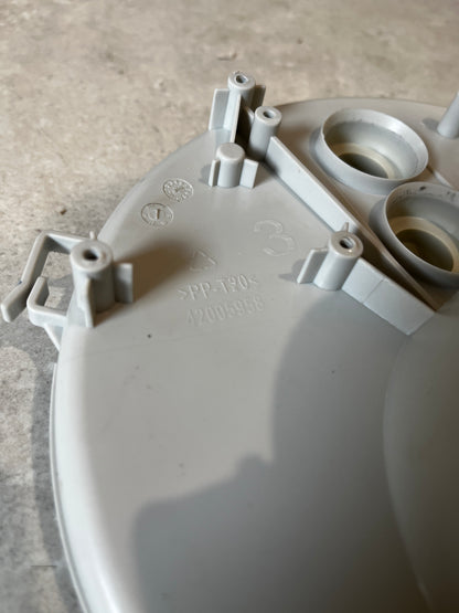 Close-up of mounting points, markings, and material info on the pump filter housing