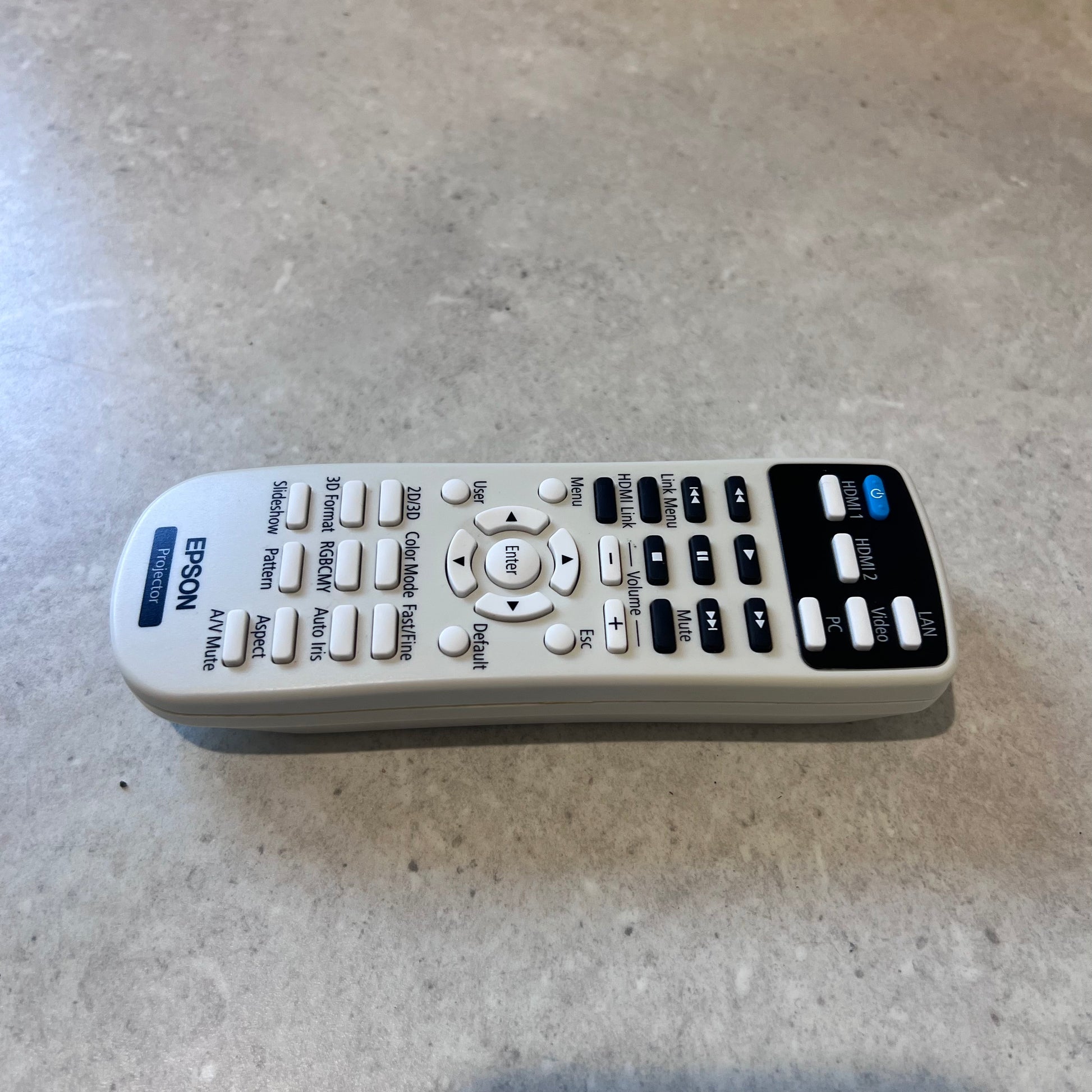 Close up of Epson projector remote control with multiple function buttons