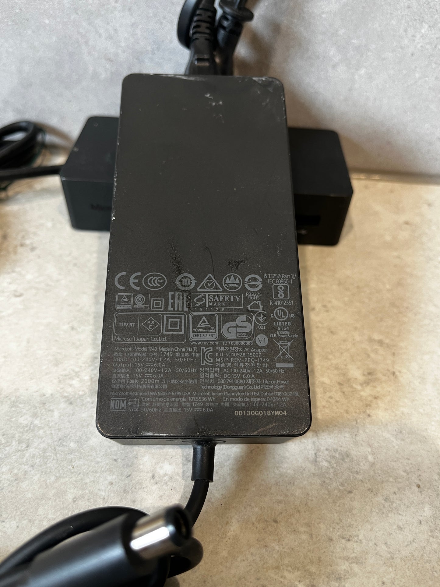 Microsoft Surface power adapter showing product label and certifications