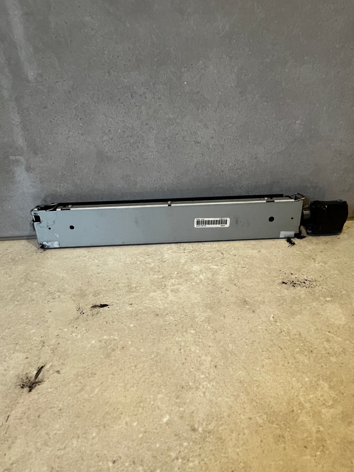 Back view of printer fuser assembly with model and barcode label