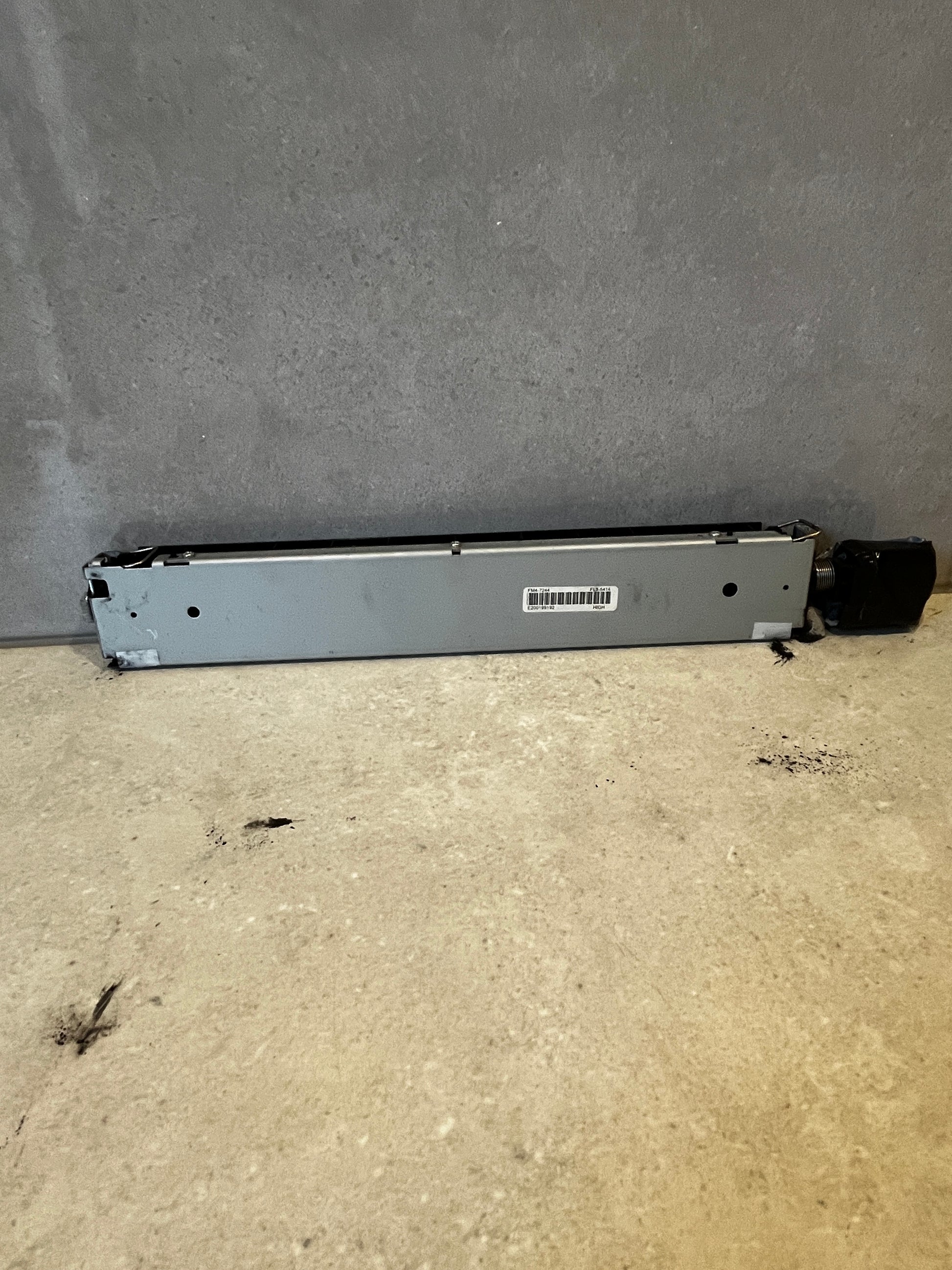 Back view of printer fuser assembly with model and barcode label