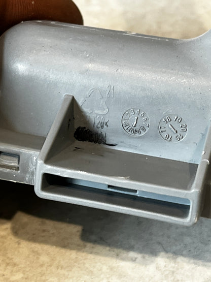 Close-up of markings and recycling symbol on dishwasher spray arm support
