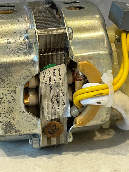 Close-up of motor label showing voltage and manufacturer details