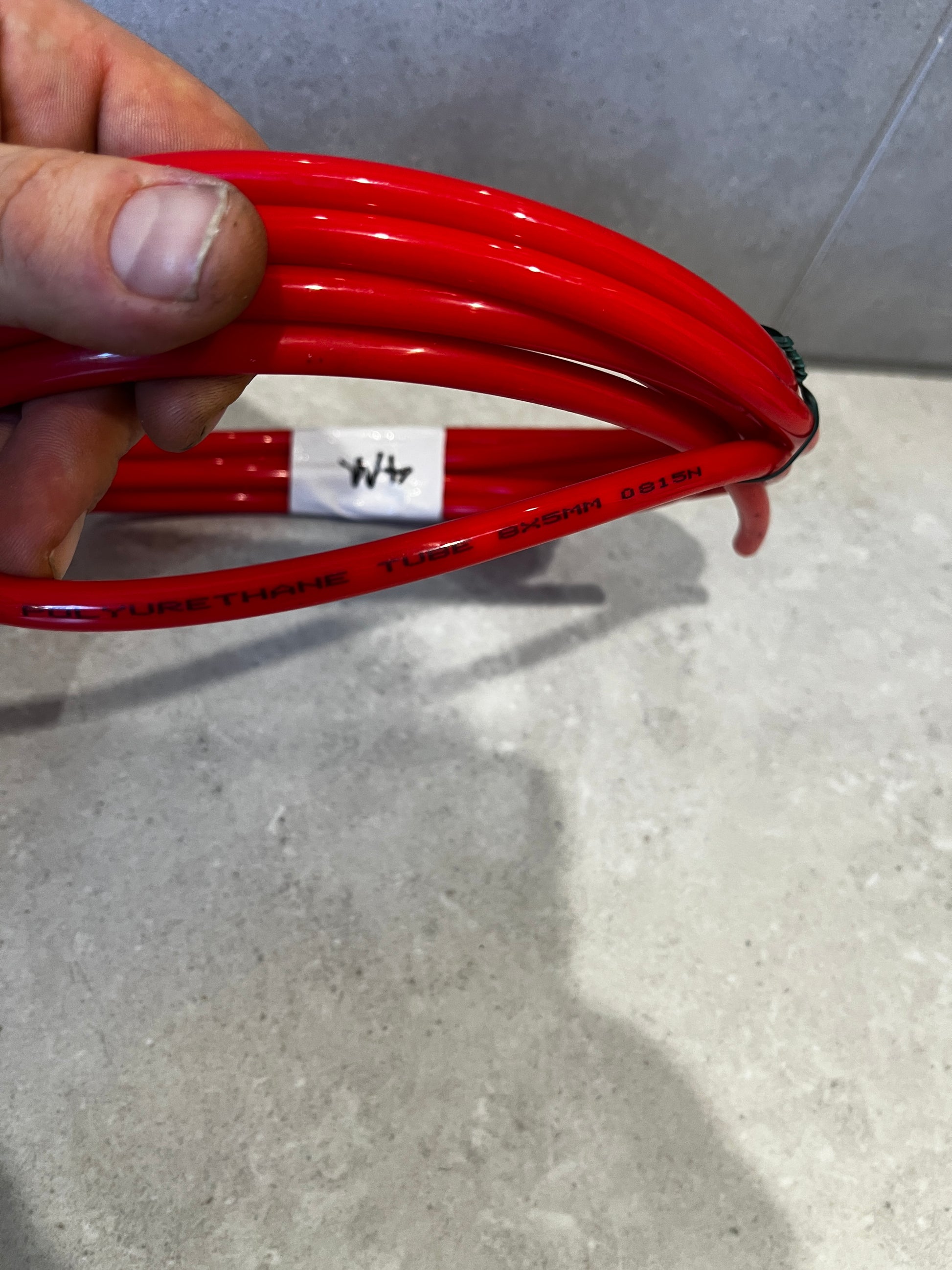 Detailed shot of red polyurethane tube marked with size 8x5mm and material info