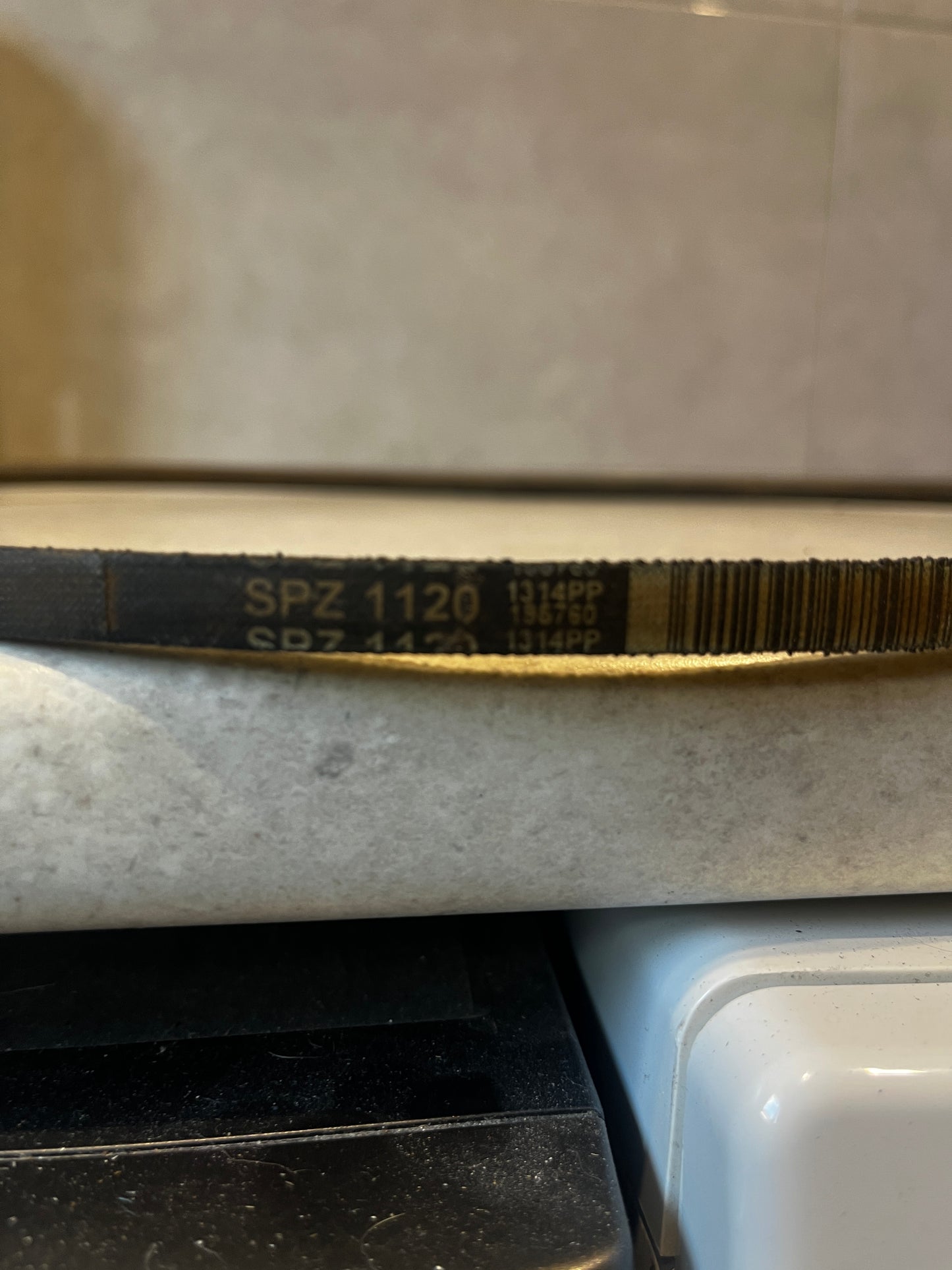 Detailed view of SPZ 1120 marking on industrial V-belt