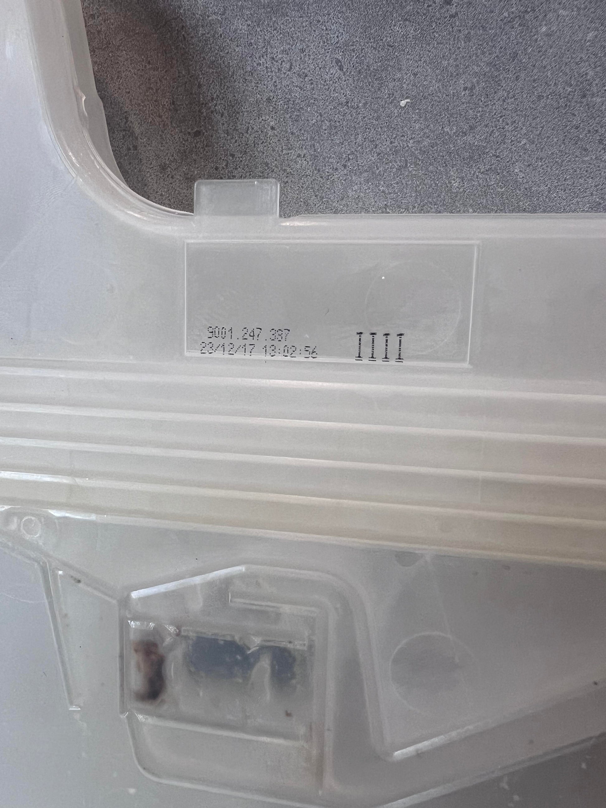 Close-up of stamped serial number on dishwasher inlet valve plastic housing
