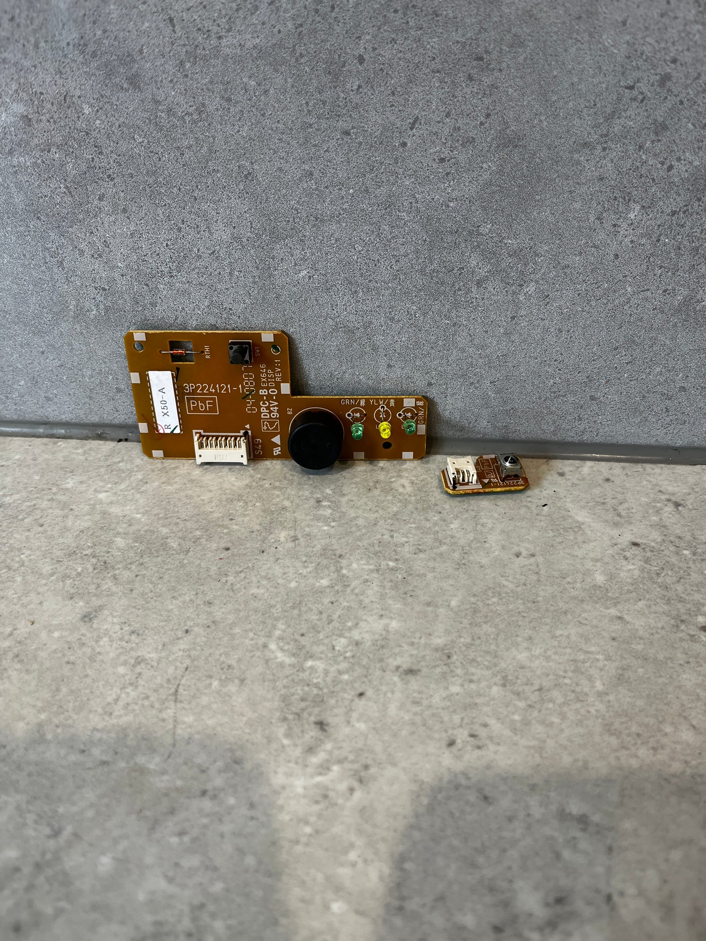 Daikin circuit board assembly with additional small board on gray background
