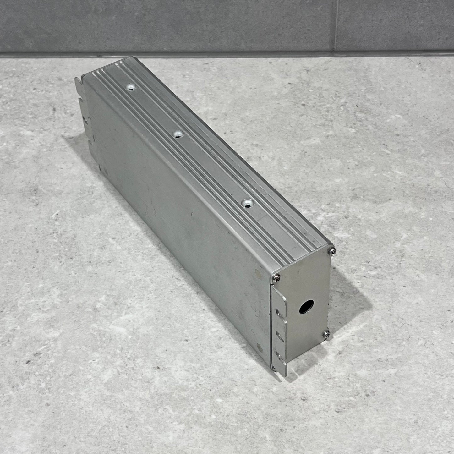 Angled top-down view of aluminum project box showing mounting features and finishes