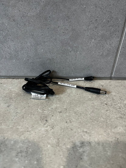 TEC-C base adapter cable coiled on surface, showing both connectors and labels