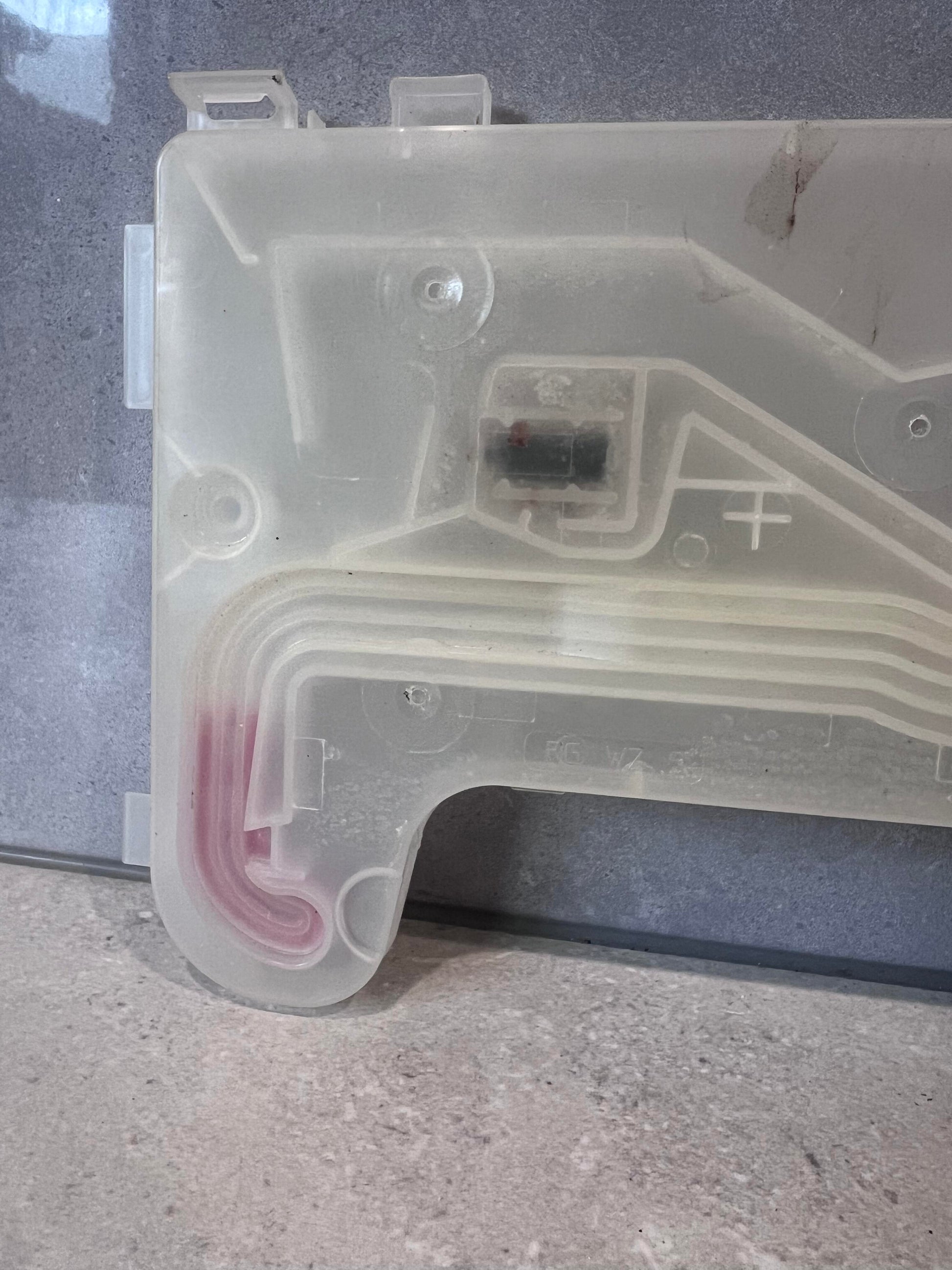 Corner detail of translucent dishwasher inlet valve showing channel and insert