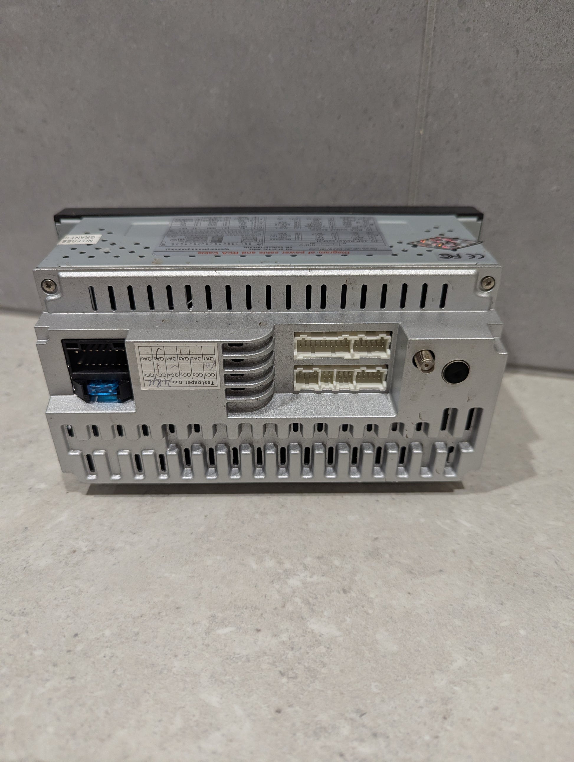 Rear view of car stereo head unit showing multiple input and output connectors