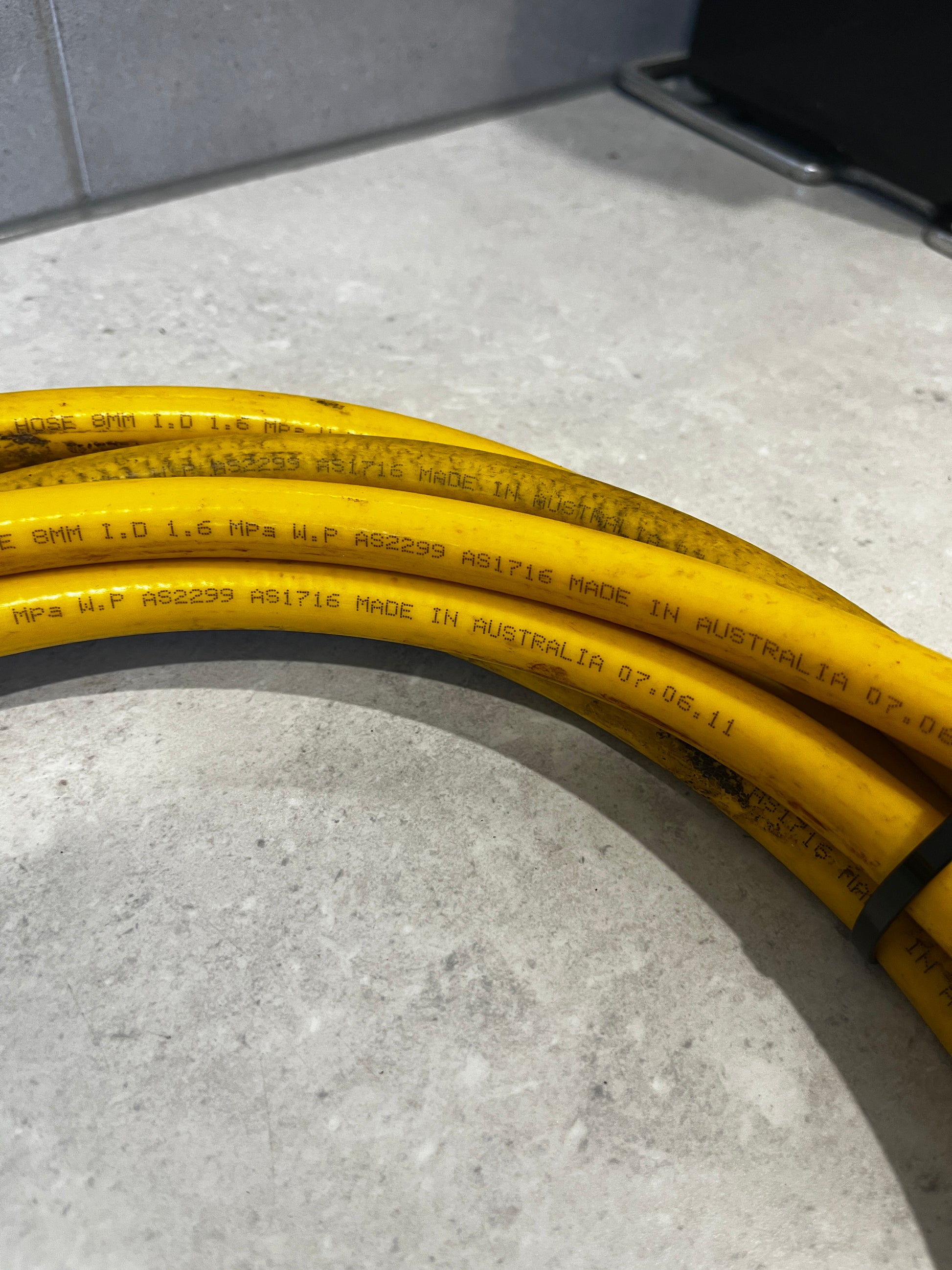 Close-up showing AS2299 compliance and Australian manufacturing marking on hose