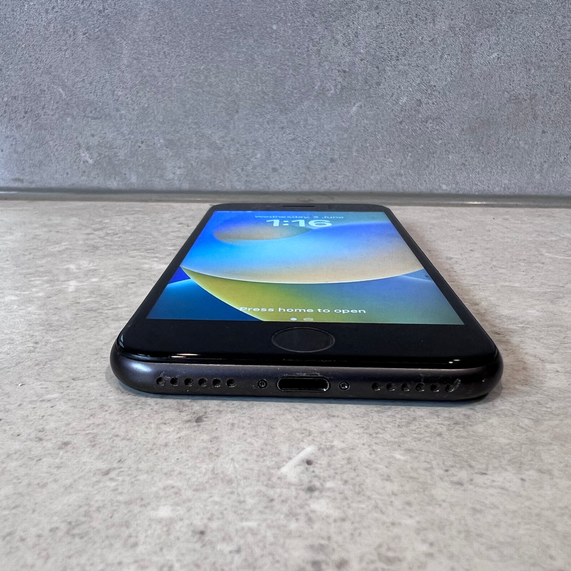 Bottom view showing charging port and speakers on iPhone 8