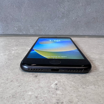 Bottom view showing charging port and speakers on iPhone 8