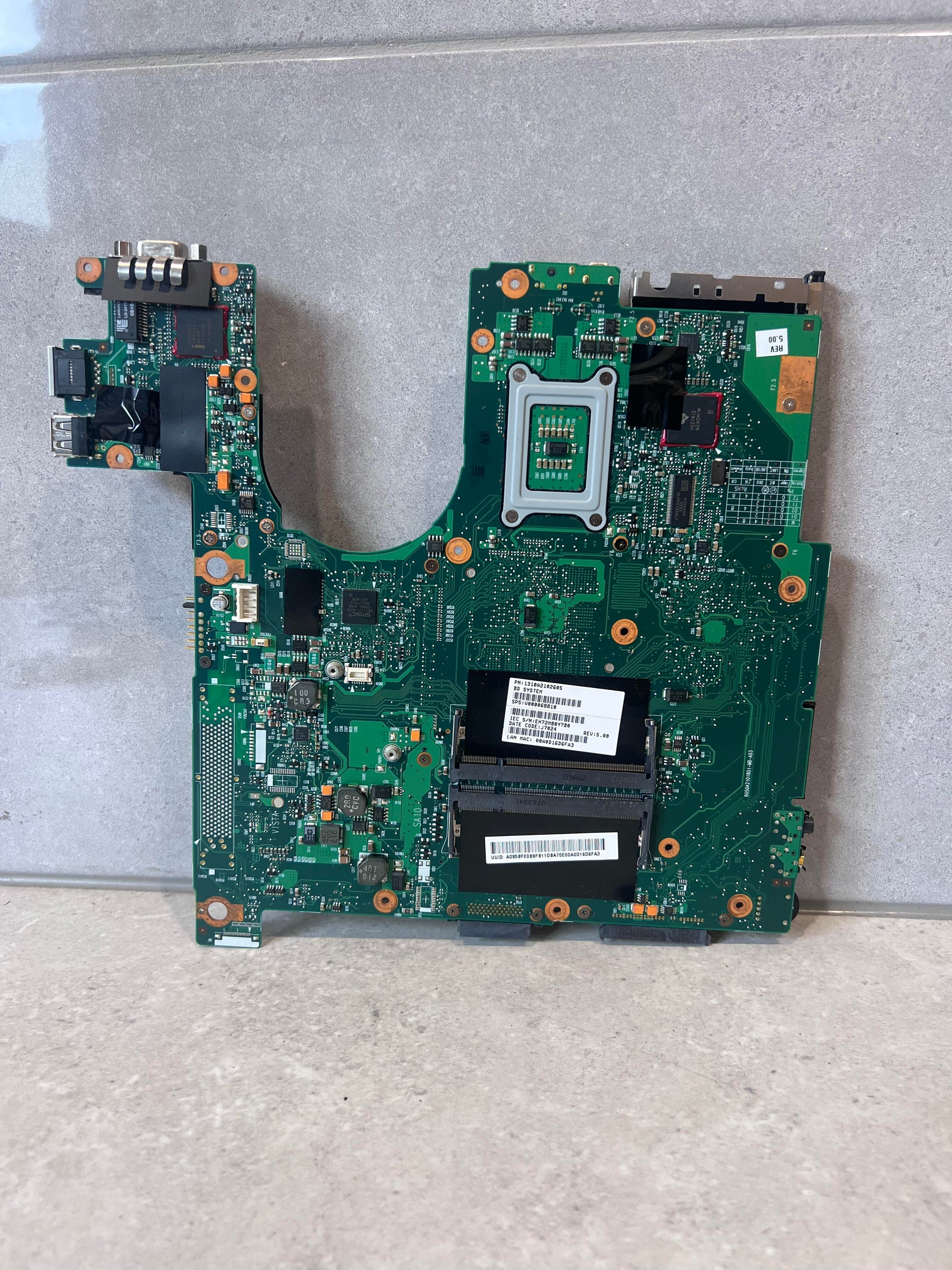 Rear view of laptop motherboard with component slots