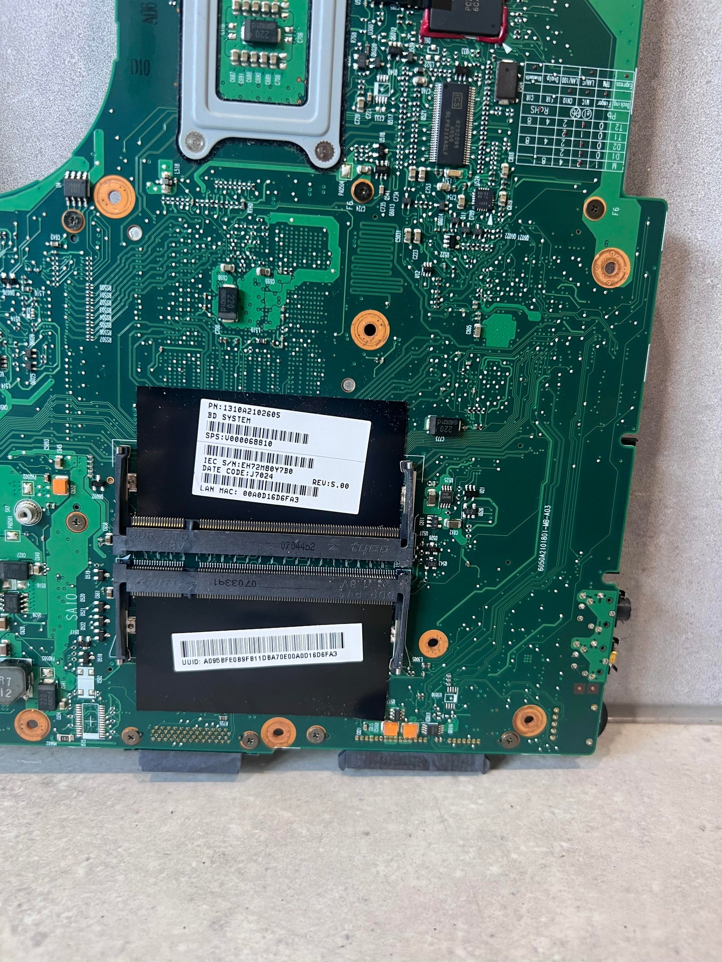 Close-up of memory slots and labels on laptop motherboard