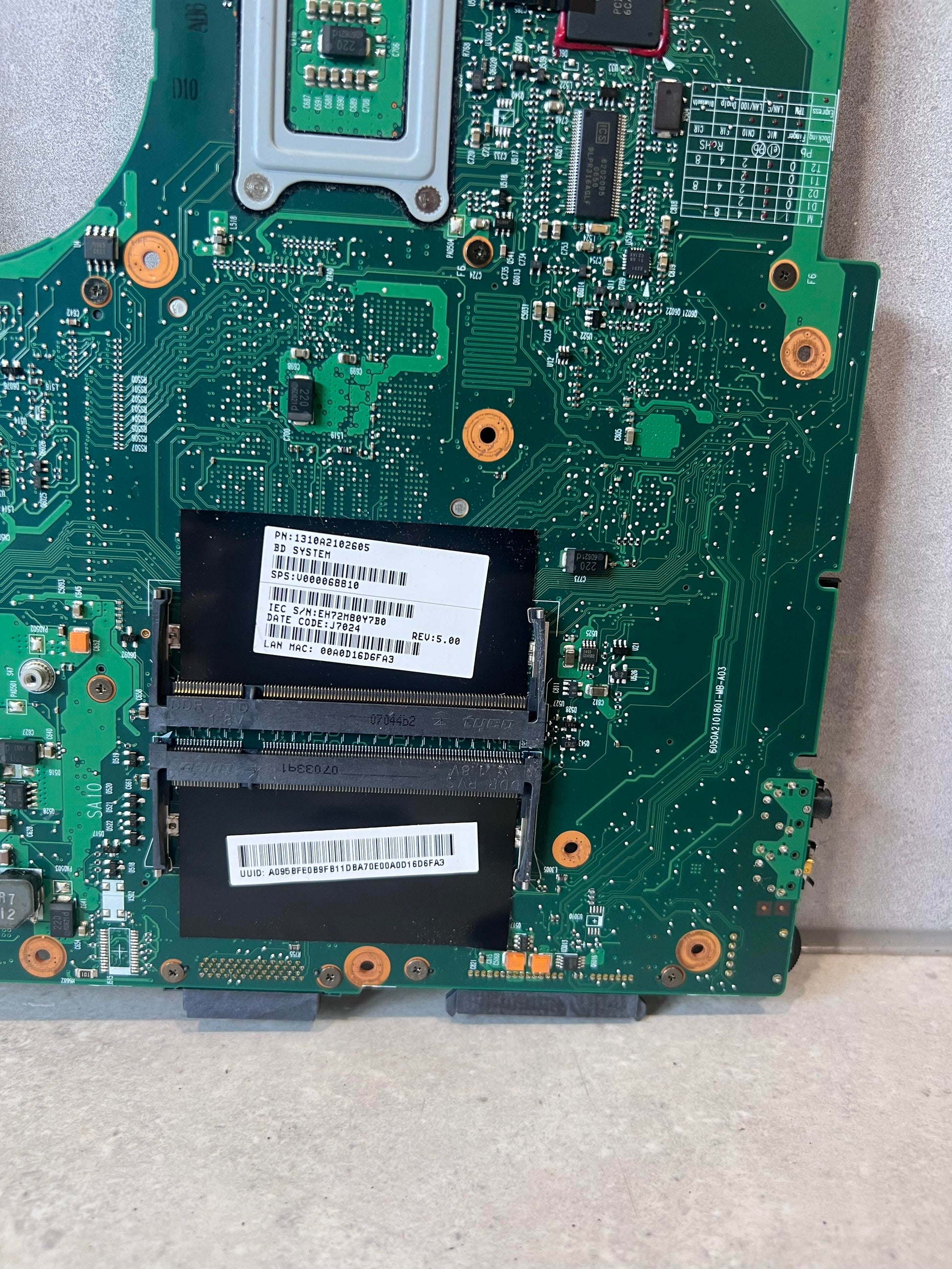Close-up of memory slots and labels on laptop motherboard
