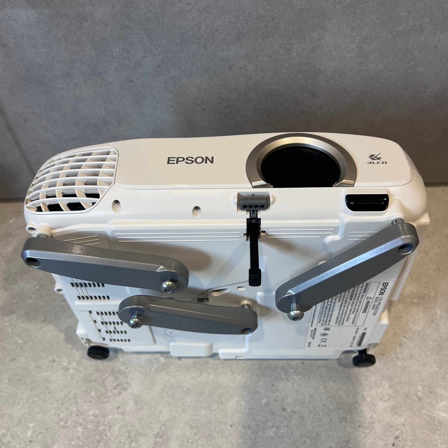 Bottom alternate angle of Epson EH-TW5200 projector displaying adjustable feet and mounting points